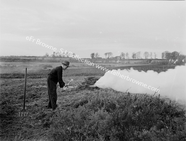 FARMER MAKING BONFIRE